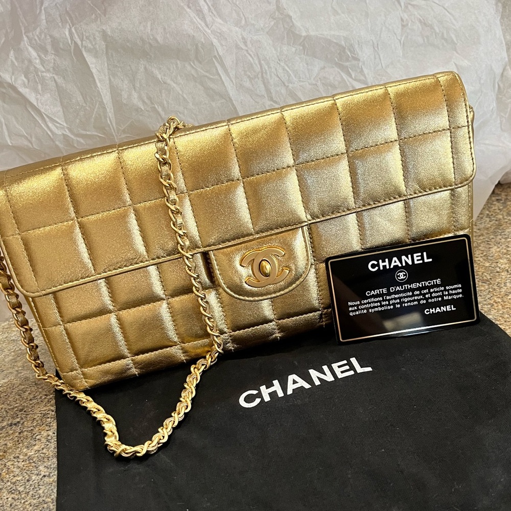 Vintage golden Chanel clutch with strap (10in). Dust bag and authenticity card.